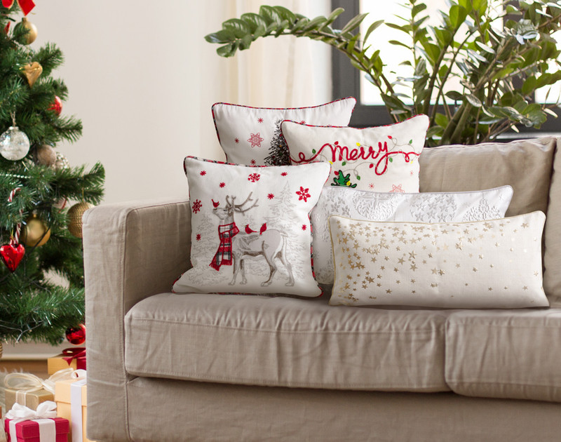 Our Holiday Cushions all resting on a festive living room couch.