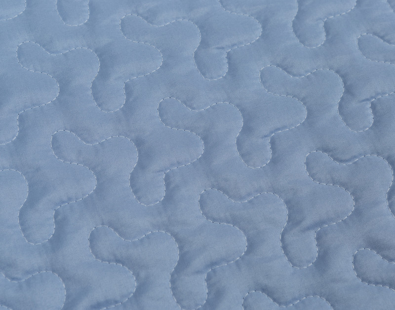 Close-up on the solid blue reverse on our Periwinkle Coverlet Set.