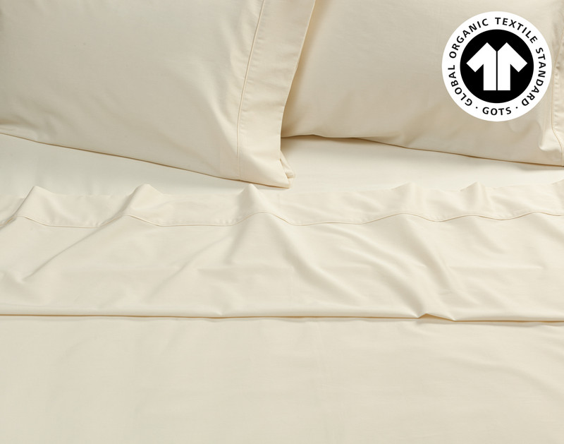 Top view of the flat sheet and pillowcases over a fitted sheet for our Undyed & Unbleached Organic Cotton Sateen Sheet Set.