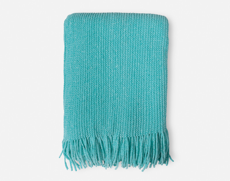 Our Chenille Throw in Turquoise folded into a tidy square to show its fringed edges.