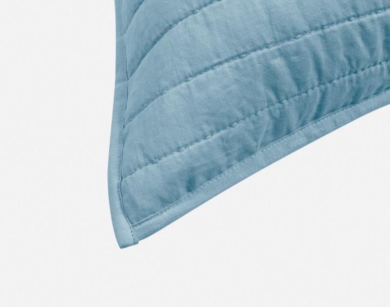 Close-up on the light flanged edge on the corner of our Linen Cotton Euro Sham in Lake.