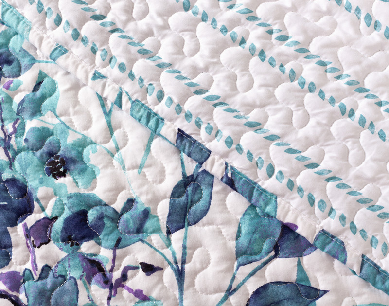 Folded edge on our Bayou Coverlet Set to show its surface and reverse side-by-side.