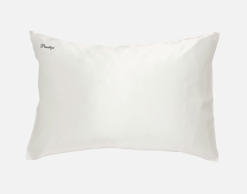 Front view of our Snow White Mulberry Silk Pillowcase, featuring the word "Prestige" embroidered in black thread in our cursive Prestige font in its upper-left corner.