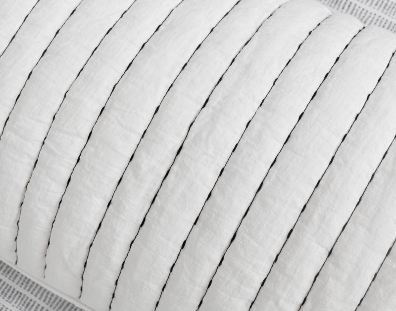 Close-up on the pick-stitched vertical lines and lightly textured fabric on our Shyla Lumbar Pillow.