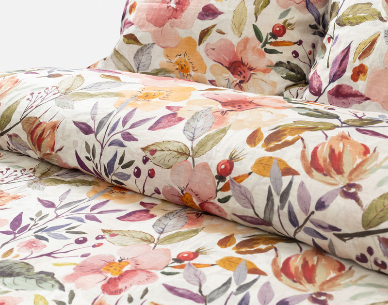 Angled view of the rolled top edge of our Marsala Duvet Cover to showcase its stylish watercolour floral design.