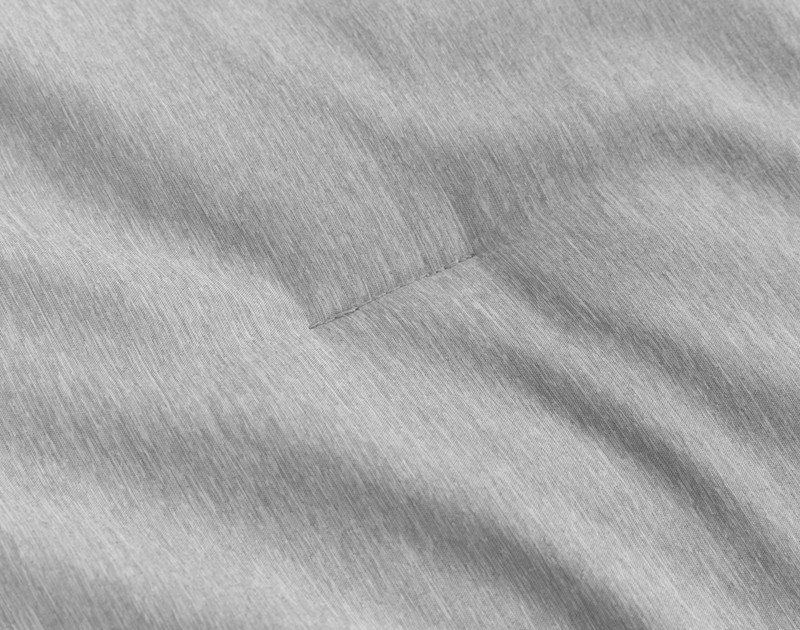 Close-up on some of the top-stitching that keeps the fill in place on our Heathered Jacquard Comforter Set in Grey.