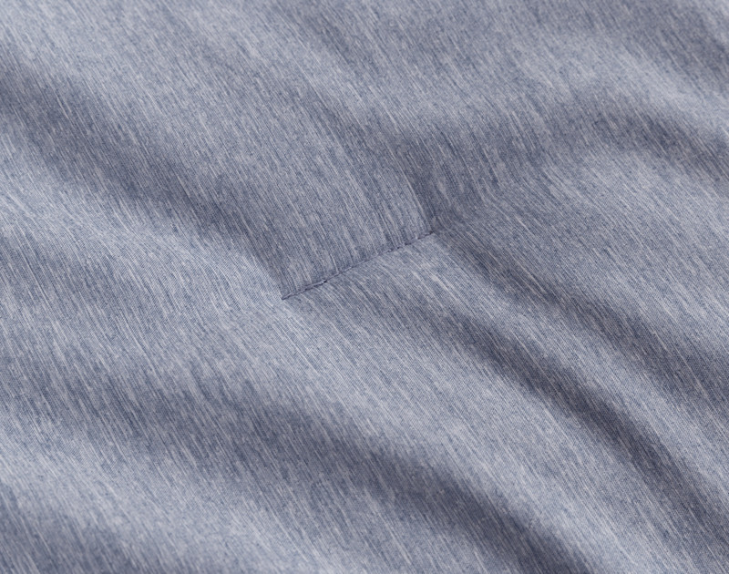 Close-up on some of the top-stitching that keeps the fill in place on our Heathered Jacquard Comforter Set in Navy.