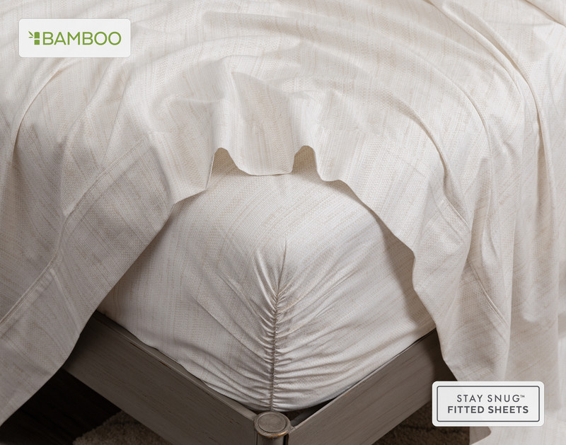 Flat sheet draped over our Bamboo Cotton Fitted Sheet in Crosshatch around the corner of a mattress.