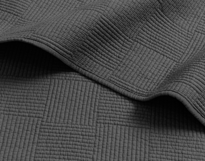 Folded edge on our Kenzie Cotton Quilt Set in Black Pearl to show its hemmed border.