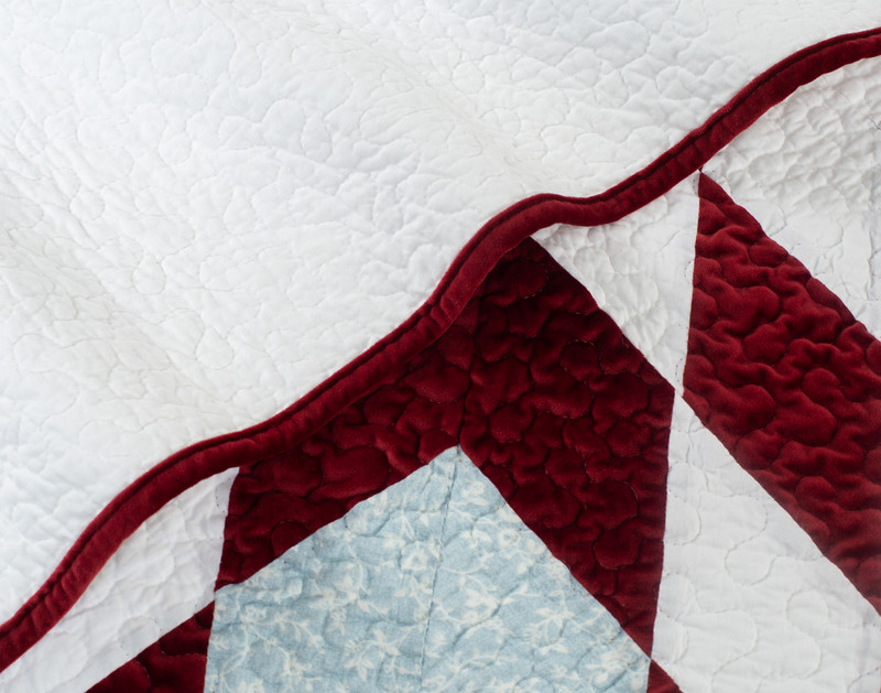 Close-up on the red bordered edge on our Noelle Star Quilt Set.