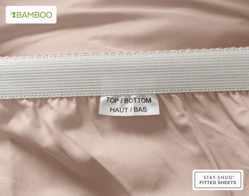 Edge of our Bamboo Cotton Fitted Sheet in Frosted Berry to show a tag stating "Top" and "Bottom."