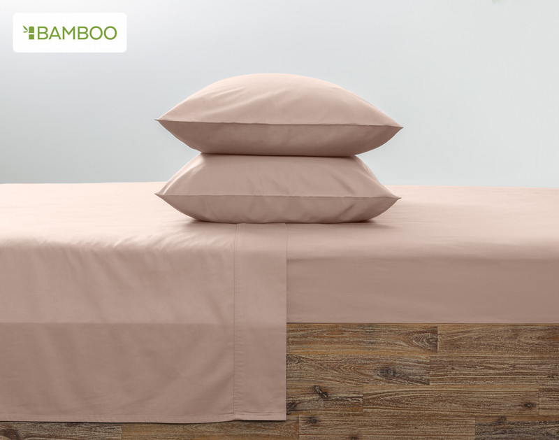 Two of our Bamboo Cotton Pillowcases in Frosted Berry Pink stacked on top of each other on a coordinating pink bed.