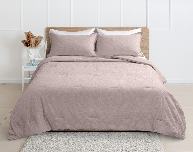 Front view of our Cortina Cotton Matelassé Comforter Set in Heather dressed over a queen bed in a clean white bedroom.