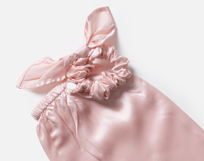 Close-up on the scrunchie opening on our Mulberry Silk Bun Cover in Blush.
