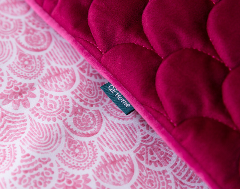 Side view of our Mambo Boudoir Pillow Cover to show its QE Home tag along its short piped edge border.