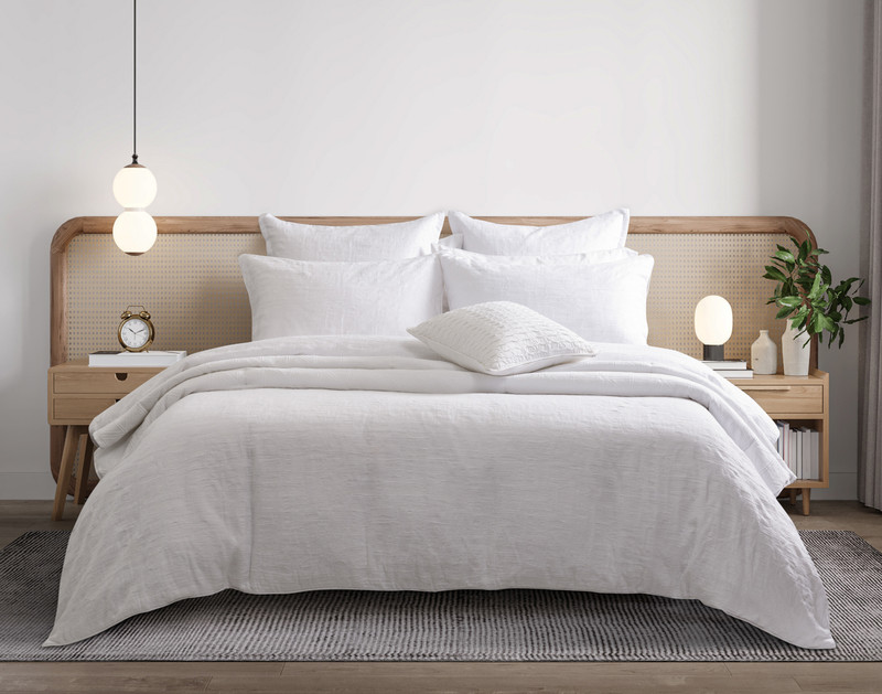 Front view of our Chalkstone Duvet Cover draped over a queen bed in a vacation-ready hotel room.