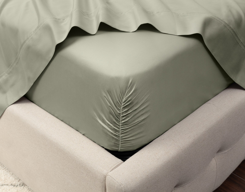 Close-up on the corner of a mattress with our Eucalyptus Luxe TENCEL™ Lyocell Fitted Sheet in Mistywoods to show its snug fit.