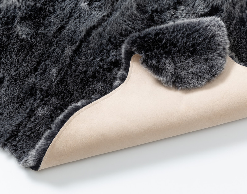 Our Polar Faux Fur Rug folded to show its smooth underside.