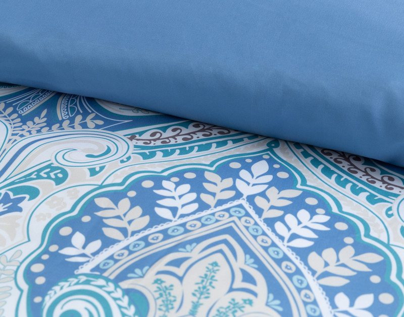 Close-up on the folded top edge of our Giselle Duvet Cover Set to show its surface pattern and solid reverse together.