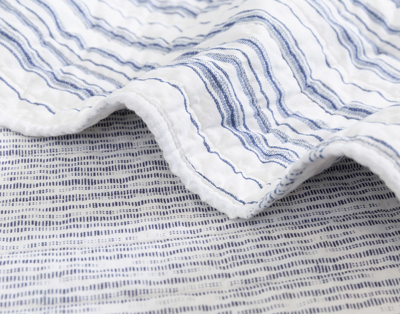 Folded edge on our Frankie Cotton Quilt Set to show two of its alternating striped patches.