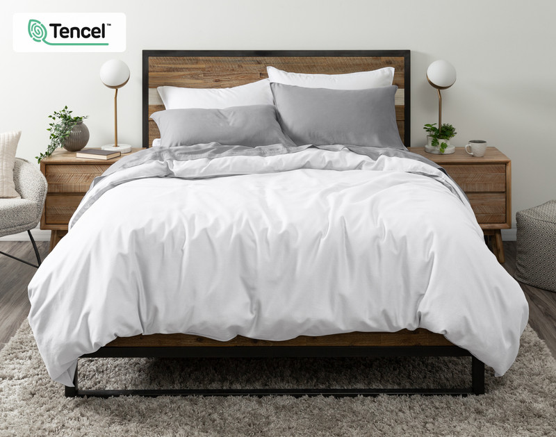 Front view of our Hemp Touch Duvet Cover in White draped over a queen bed with coordinating grey sheets and pillowcases.