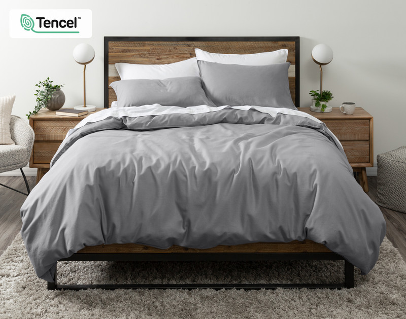 Front view of our Hemp Touch Duvet Cover in Grey draped over a queen bed with coordinating white sheets and pillowcases.