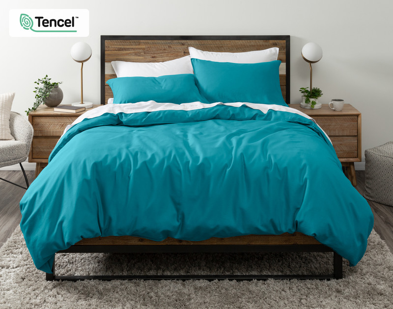 Front view of our Hemp Touch Duvet Cover in Lake Blue draped over a queen bed with coordinating sheets and pillowcases.