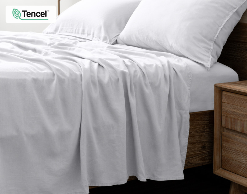 Side view of our Hemp Touch Sheet Set in White to show its flat sheet draping over its side.