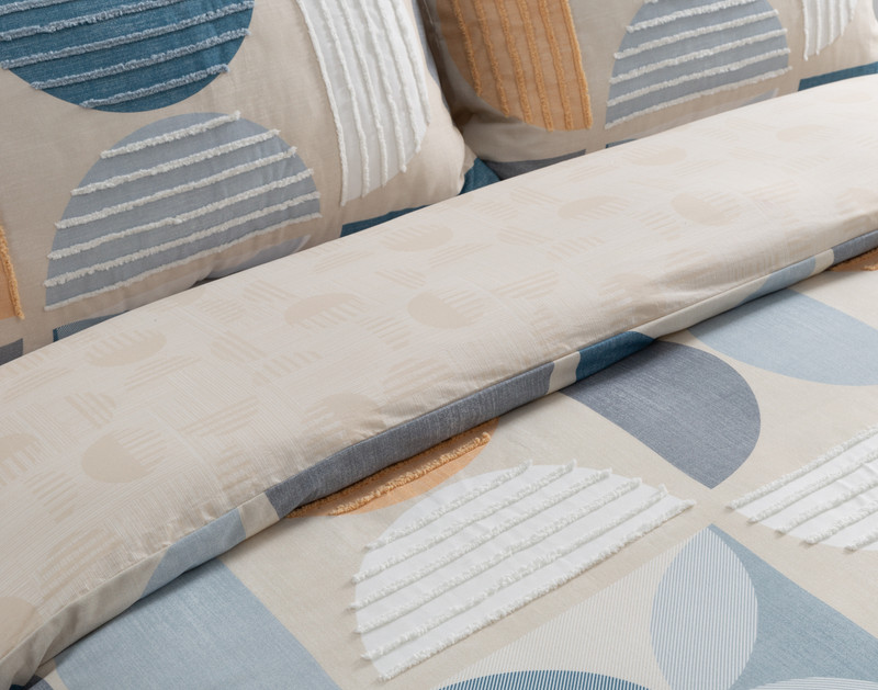 Closer view of a folded top edge on our Nora Duvet Cover to show its surface and backing patterns side-by-side.