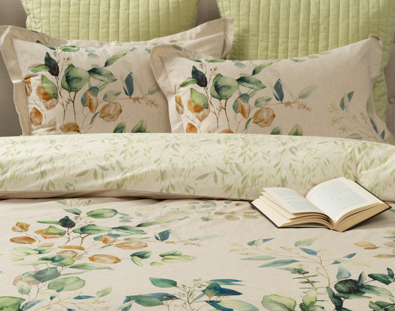 Front view of our Medlow Duvet Cover with coordinating pillow shams and a half-open book resting on its side.