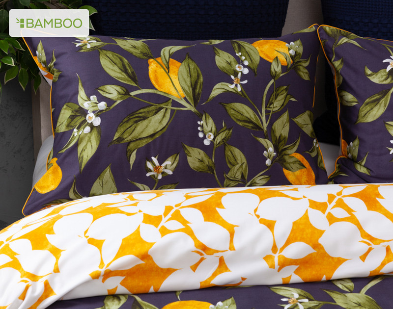 Close view of our Catarina Pillow Sham resting against coordinating cushions on a bed.