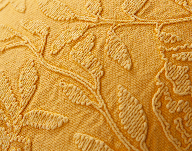 Close-up on the stitched leaves on the canvas surface of our Catarina Square Cushion Cover.