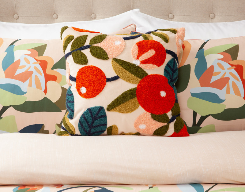 Front view of our Freya Square Cushion Cover sitting on a coordinating bed with matching duvet cover and pillow shams.