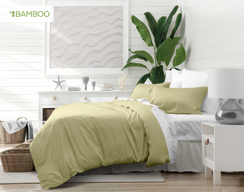 Angled view of our Bamboo Cotton Duvet Cover in Elm draped over a queen bed in a white bedroom.