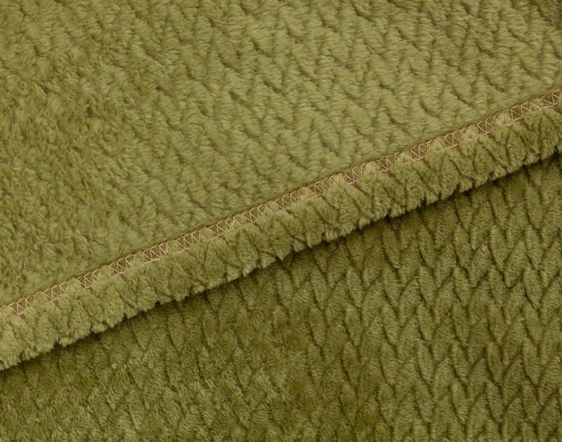 Close-up on the hemmed border on our Chevron Plush Throw in Moss to show its matching reverse and front together.
