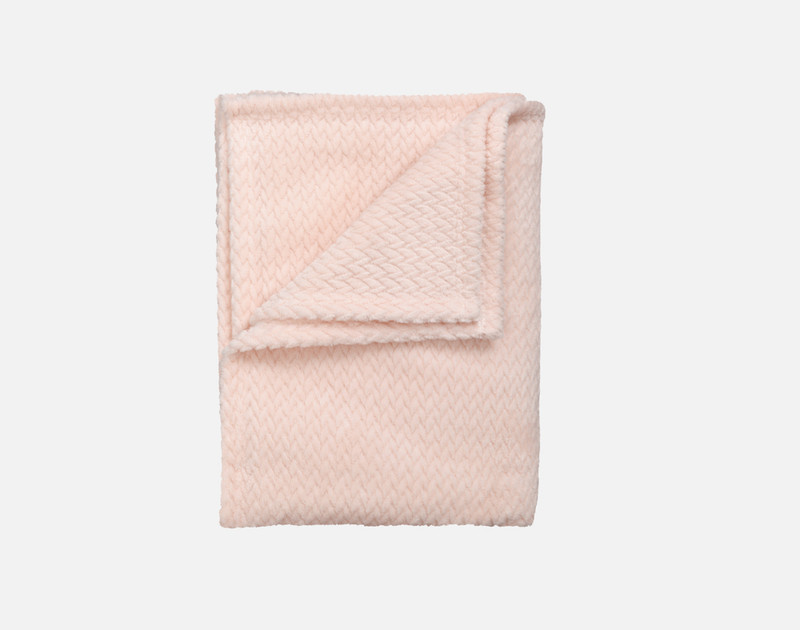 Our Chevron Plush Throw in Blush folded into a tidy square.