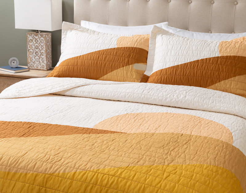 Angled view of our matching pillow shams and surface of our Golden Hills Cotton Quilt Set.