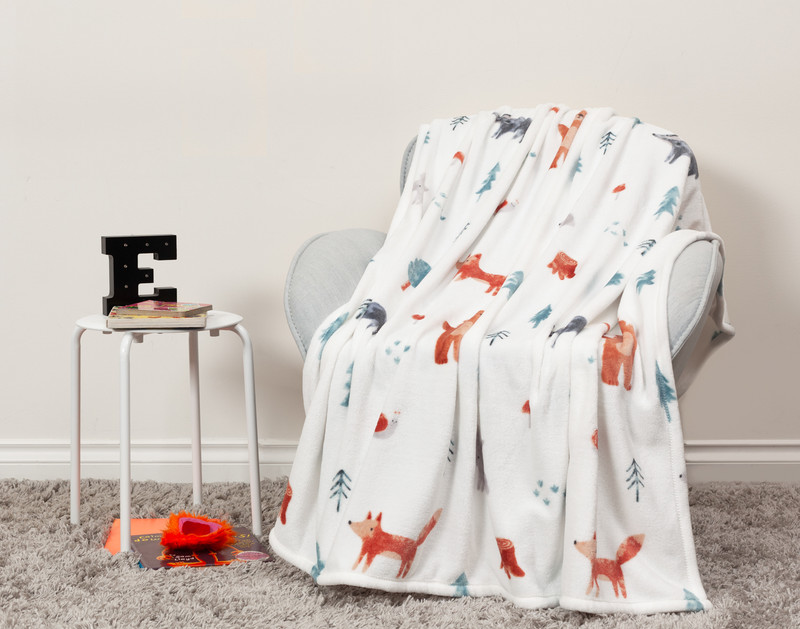 Front view of our Reddy Fox Kids' Fleece Velveteen Throw draped over a chair in a kids' room.