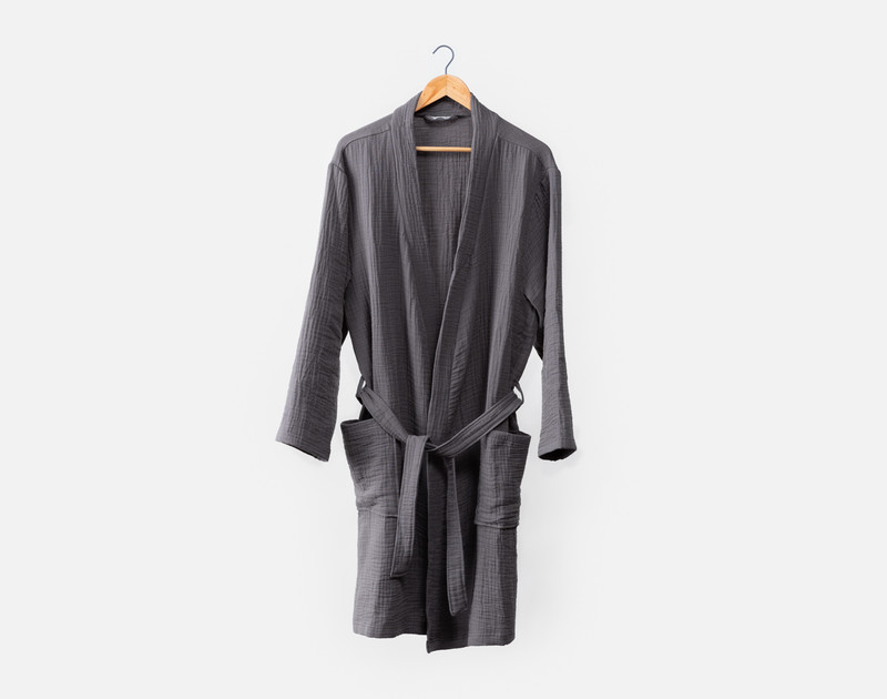 Front view of our Muslin Gauze Bathrobe in Charcoal draped on a clothes hanger.