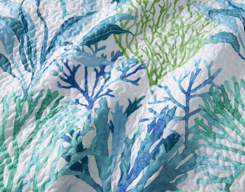 Close-up on the blue and green coral on the surface of our Nori Coverlet Set.