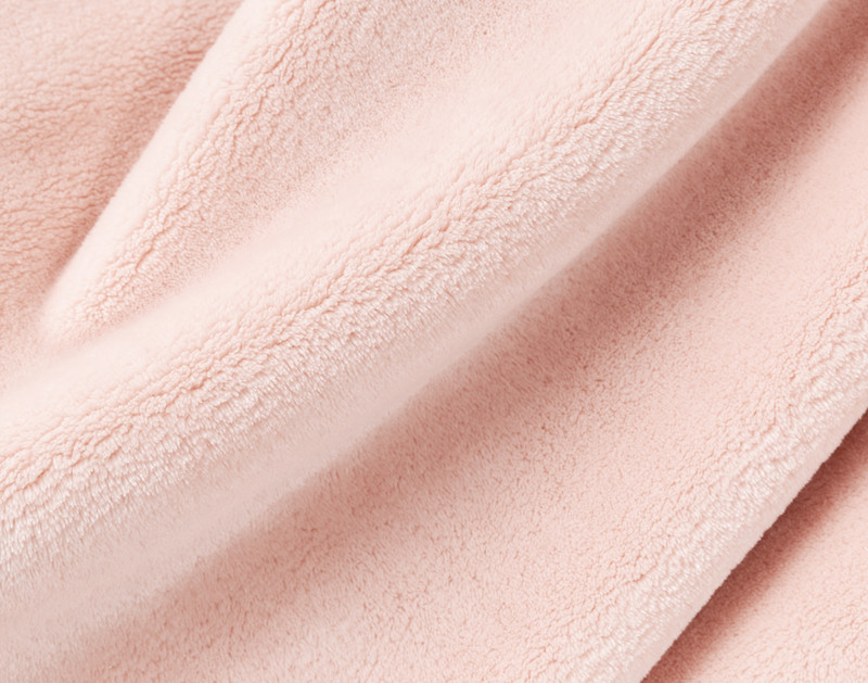 Close-up on our Velvet Plush Throw in Powder Pink to show its soft velveteen texture.