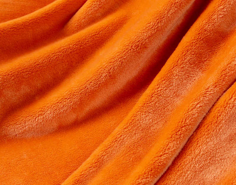 Close-up on our Velvet Plush Throw in Sundown to show its soft velveteen texture.