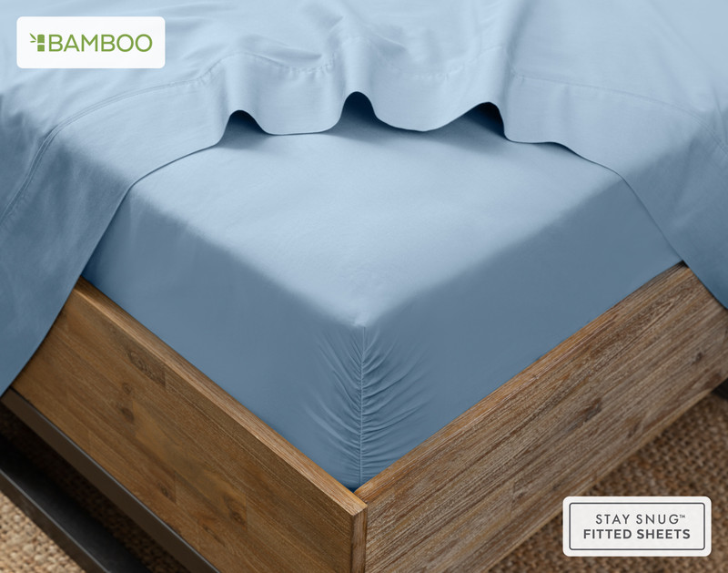 Flat sheet draped over our Bamboo Cotton Fitted Sheet in Mistral Blue around the corner of a mattress.