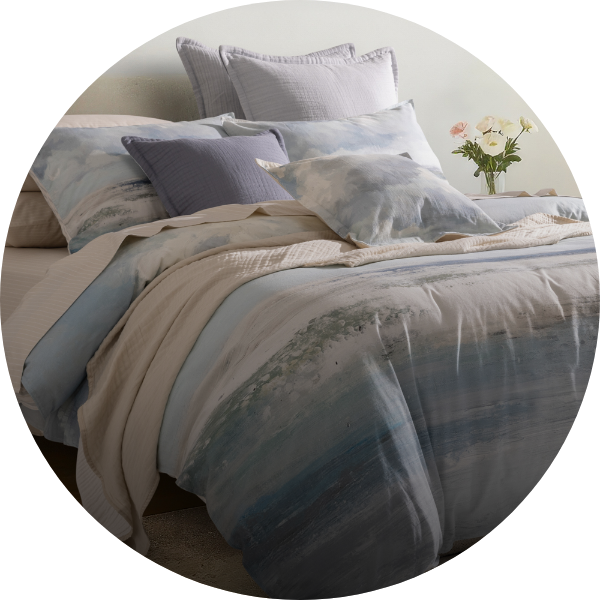 Coastal blue duvet cover over a neatly dressed bed.