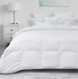 Our Cachet Hungarian Goose Down Duvet dressed over a bed in a white bedroom.