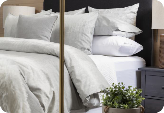 Benito Duvet Cover dressing a bed complete with white sheets and a white throw pillow. 