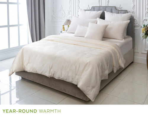 Angled view of our Fortuna Mulberry Silk Duvet in a tall hotel-style bedroom.