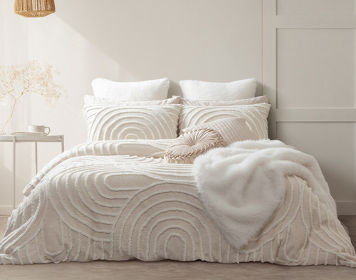 Front view of our Sonrisa Duvet Cover dressed over a queen bed with no bedframe in a white mid-century modern bedroom with white accessory blankets dressed over top.