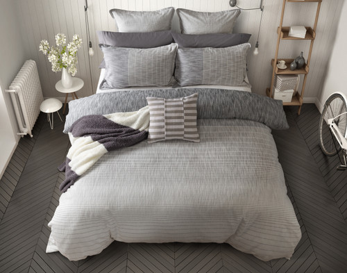 Top view of our Halston Duvet Cover dressed with coordinating grey accessories.