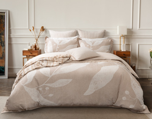 Front view of our Natura Duvet Cover dressed over a queen bed with coordinating cream and beige accessories in an elegant white bedroom.